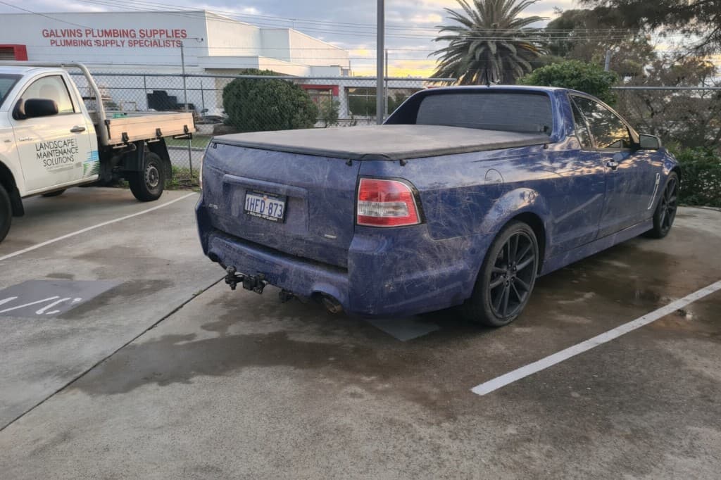 Blue Holden ute with heavy swirl marks and dull paint before paint correction in Perth